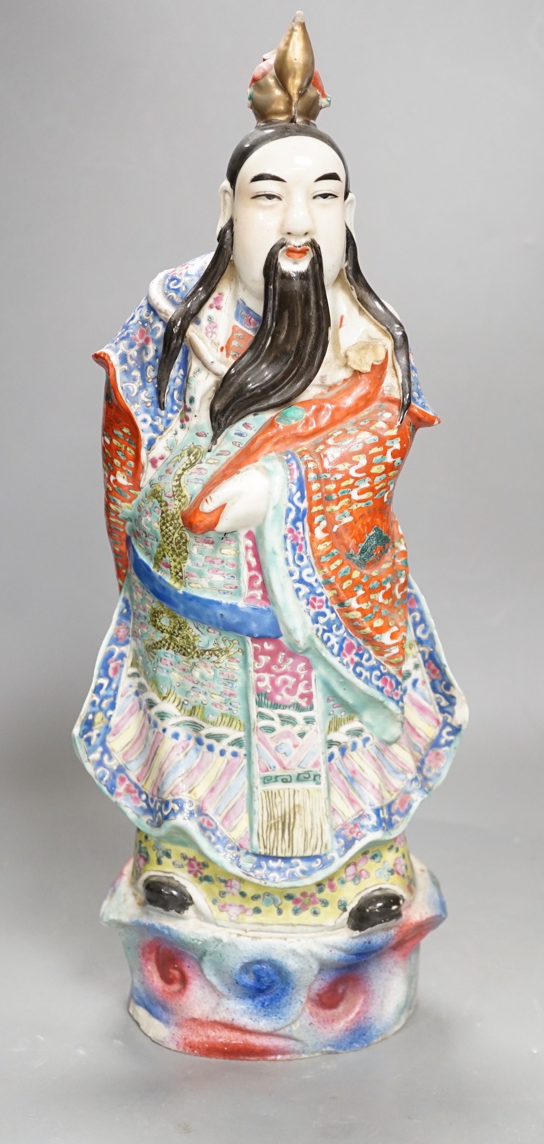 A Chinese enamelled porcelain figure of an immortal, early 20th century, 43cm